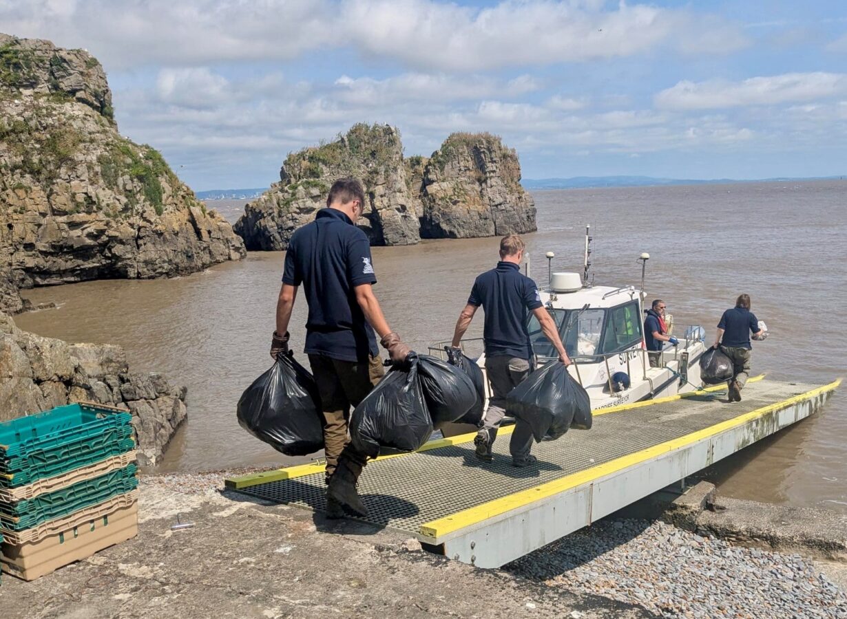 People carrying binbags to