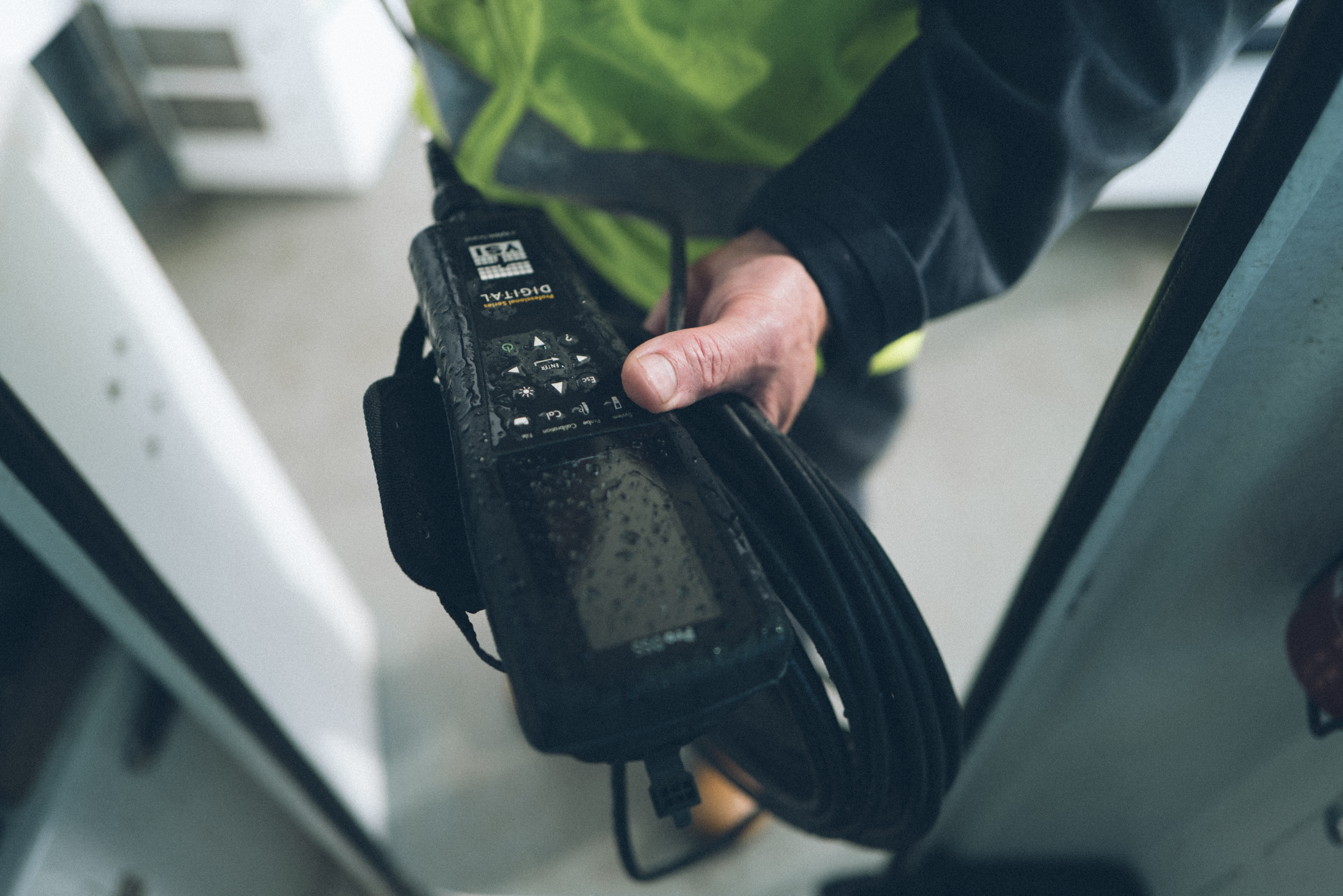 A hand holding a controller.