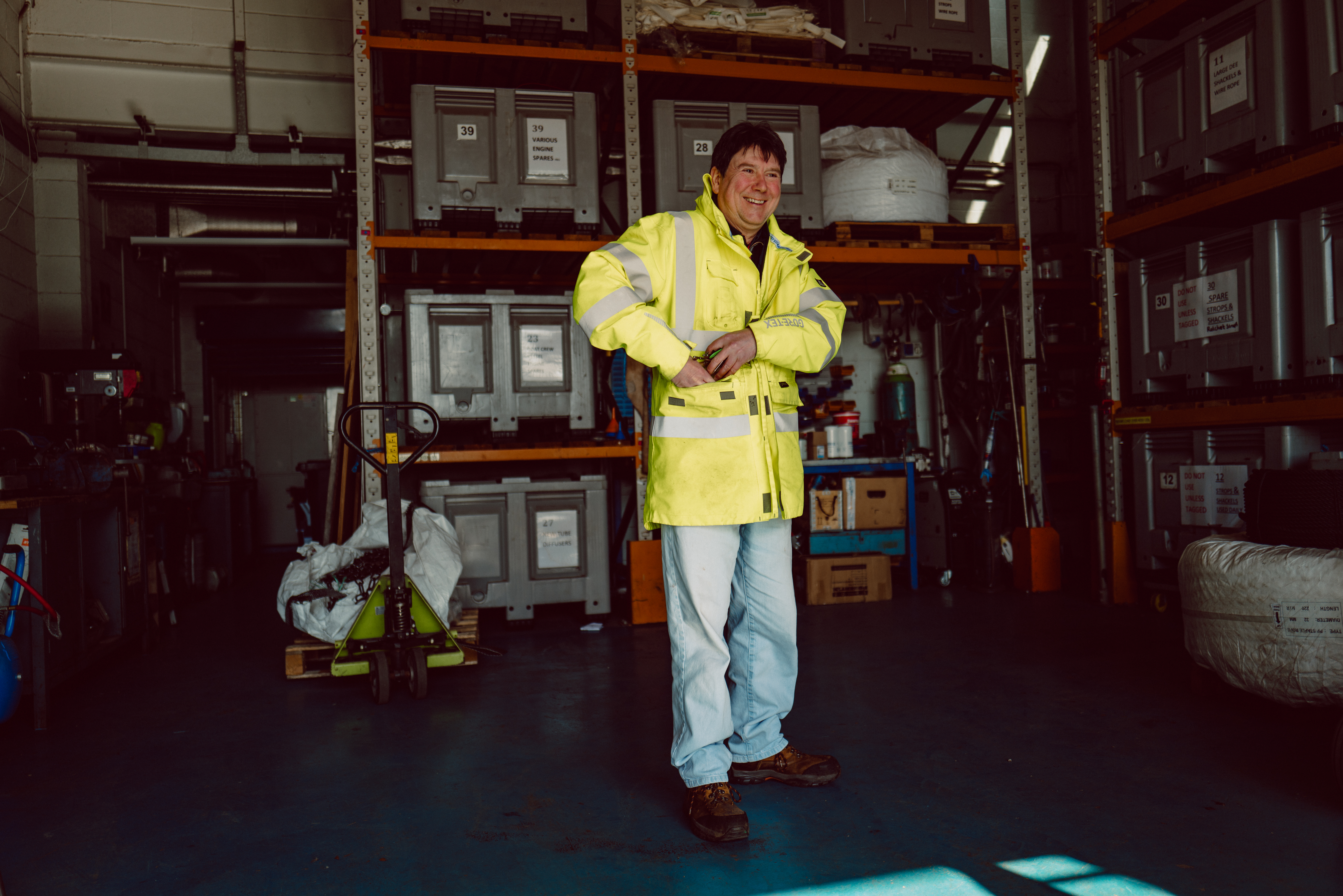 Person with hi-vis in store room