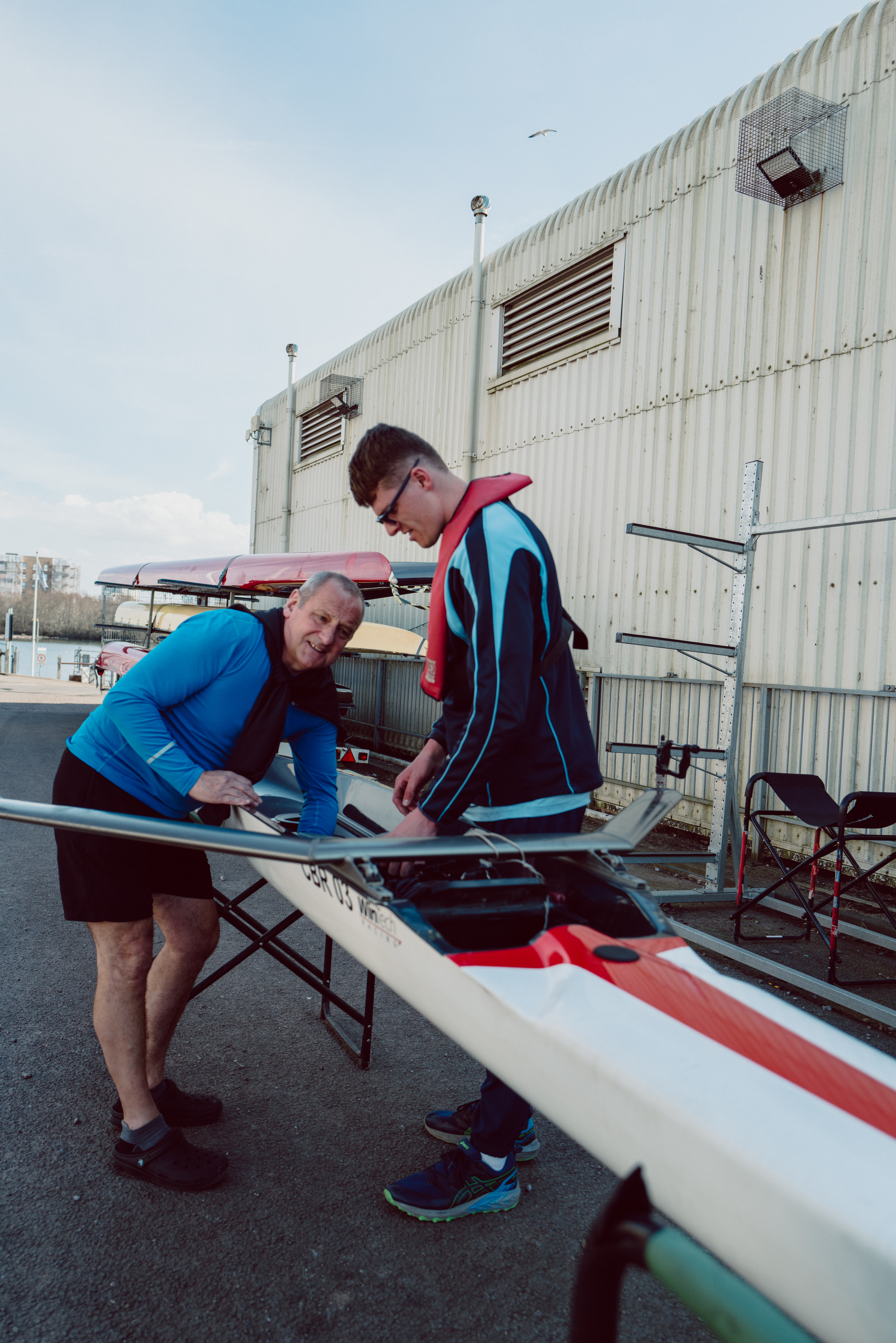Two people with a rowing boat.