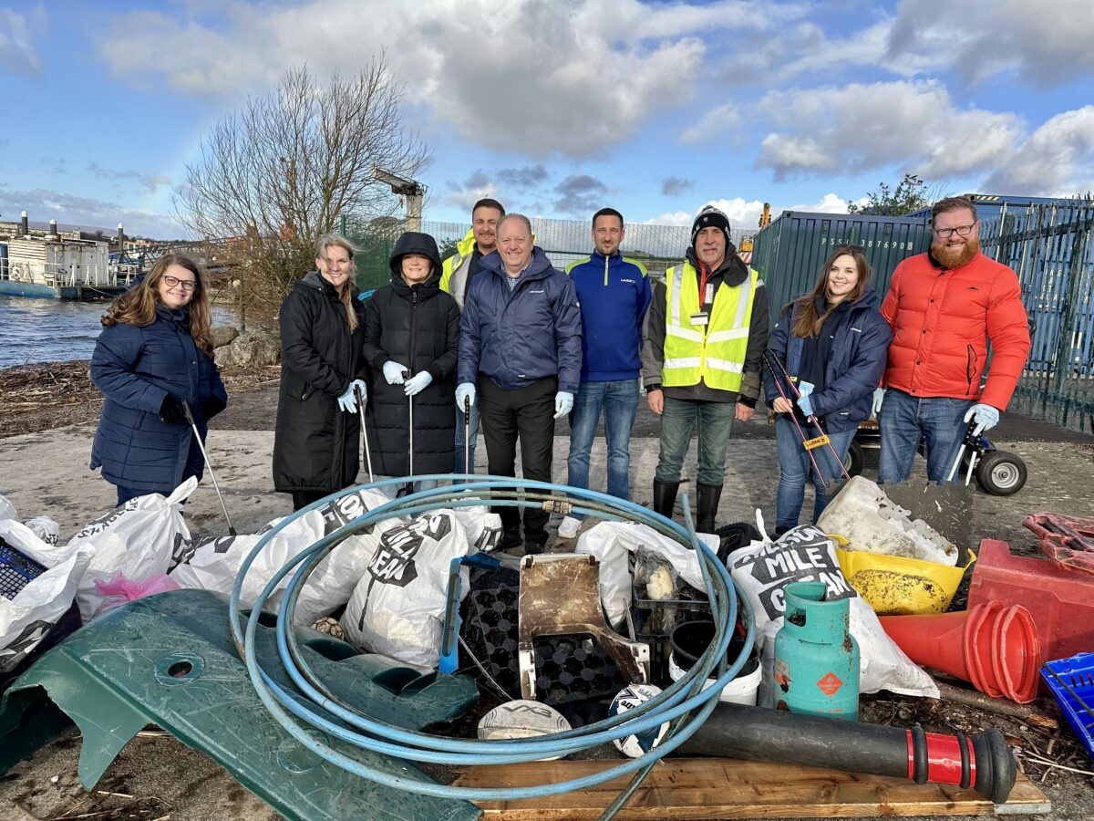Nine volunteers stood with litter after litter picking.