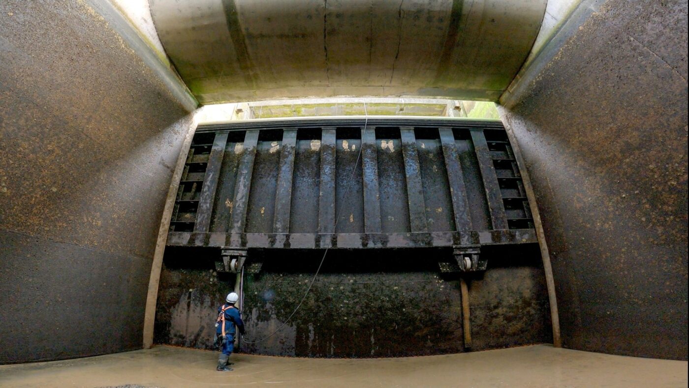 A person carrying out work on sluice gate.
